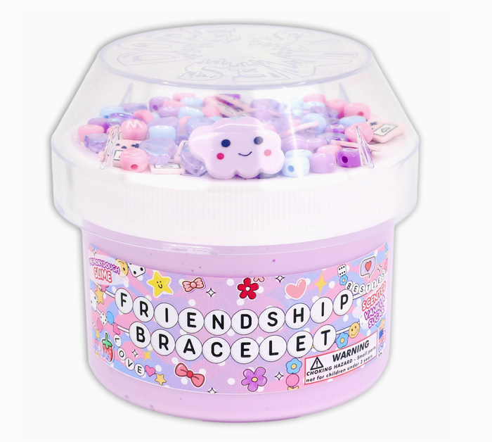 Pink container filled with colorful plush toys and a smiling cloud toy, labeled 'Friendship Bracelet'.