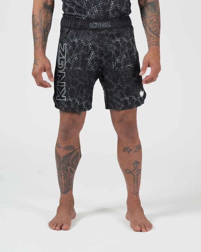 Kingz Acid Wash Shorts Black - Full Body Front View Tattooed Male Athlete Black White Dot Acid Wash Pattern KINGZ Bold Waistband Text KINGZ Large Left Leg Text Crown Badge Right Thigh Competition Cut Men's Grappling Shorts No-Gi BJJ [color:Black/Patterned]