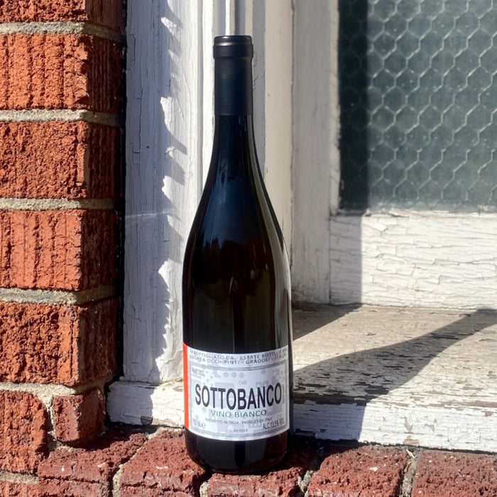 Andrea Occhipinti Sottobanco white wine bottle, 2023, front label visible on dark glass