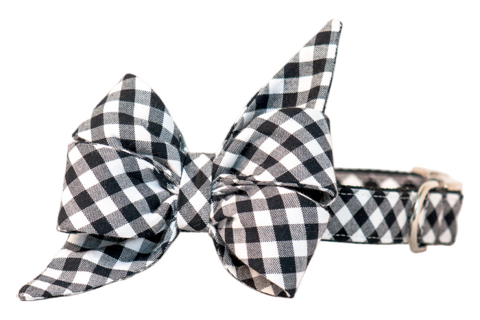 Dog collar in classic black picnic plaid with a dramatic belle bow that has long, pointed ends. The cozy checkered pattern adds rustic picnic charm, making it perfect for dogs to wear during outdoor gatherings, fall strolls, or festive family photos