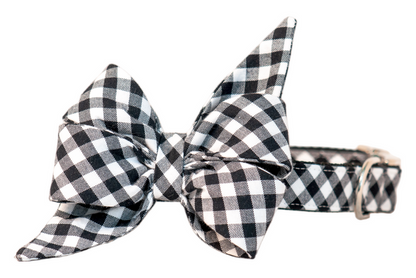 Dog collar in classic black picnic plaid with a dramatic belle bow that has long, pointed ends. The cozy checkered pattern adds rustic picnic charm, making it perfect for dogs to wear during outdoor gatherings, fall strolls, or festive family photos