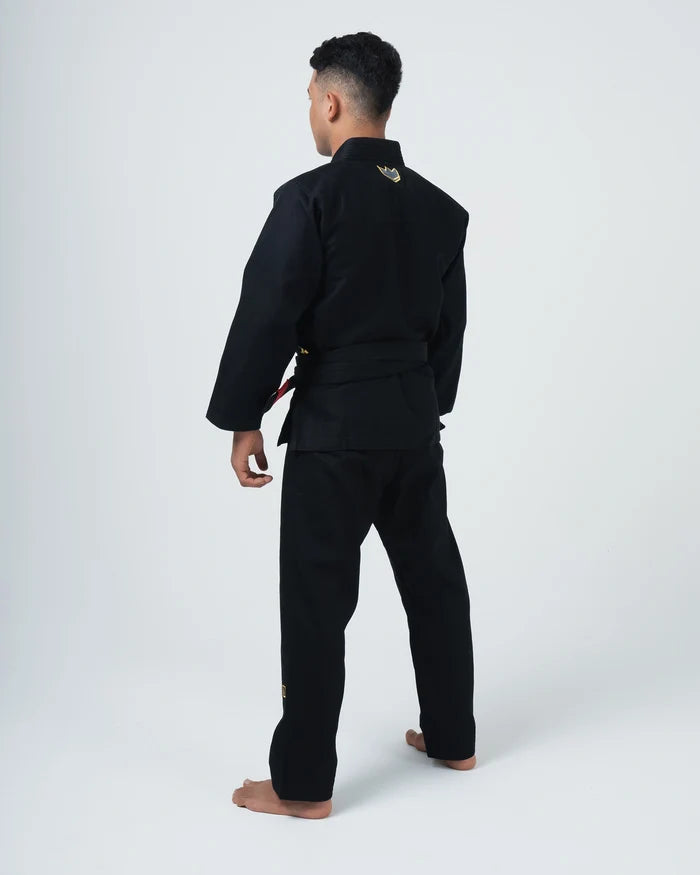 Kingz Comp 450 V6 BJJ Gi Black - Full Back View Male Athlete Wearing Black Competition Kimono Gold Crown Logo Back Collar Barefoot