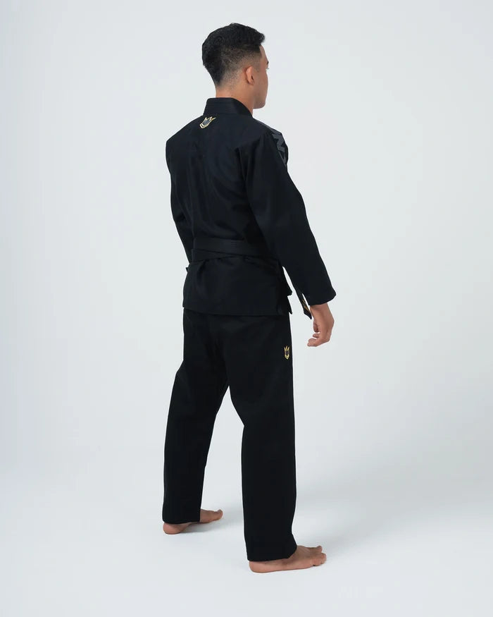 Kingz Comp 450 V6 BJJ Gi Black - 3/4 Angled Back View Male Athlete Black Competition Gi Gold Crown Logo Collar Hip Patch Black Belt