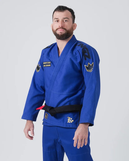 Kingz Comp 450 V6 Jiu Jitsu Gi - Blue - Front View Male Athlete Blue Gi Gold Crown Shoulder Patch Heavy Lies The Crown Text Black Belt Contrast Stitching BJJ Training Gi [color:Blue]