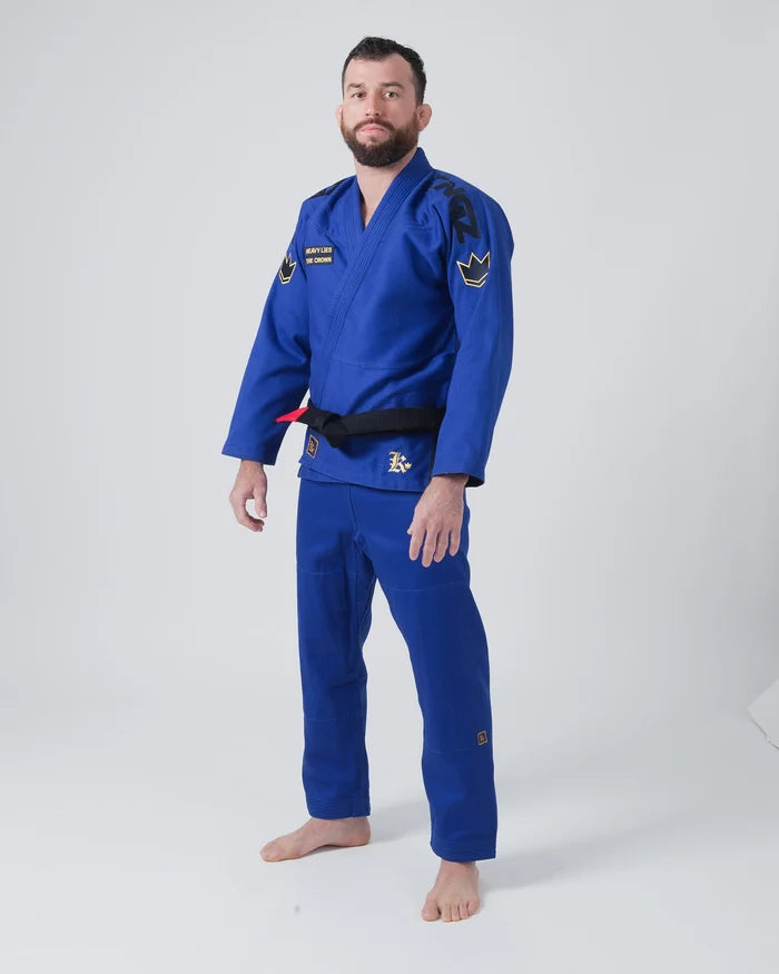 Kingz Comp 450 V6 Jiu Jitsu Gi Blue - Full Body Front View Male Athlete Black Crown Shoulder Patches Yellow Text Chest Logo Black Belt Premium Fabric BJJ Gi Training Gear [color:Blue]