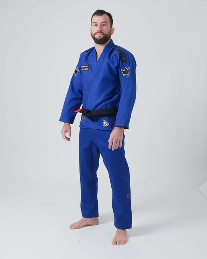 Kingz Comp 450 V6 Jiu Jitsu Gi Blue - Full Body Front View Male Athlete Black Crown Shoulder Patches Yellow Text Chest Logo Black Belt Premium Fabric BJJ Gi Training Gear [color:Blue]