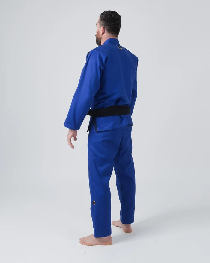 Kingz Comp 450 V6 Jiu Jitsu Gi Blue - Back View Male Athlete Solid Blue Gi Black Belt Crown Badge Neck and Pant Leg Durable Fabric BJJ Training Gi [color:Blue]