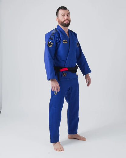 Kingz Comp 450 V6 Jiu Jitsu Gi - Blue - Full Body Front View Male Athlete Blue Gi Black KINGZ Shoulder Text Yellow Crown Badge Chest and Pants Durable Stitching BJJ Training Gi [color:Blue]