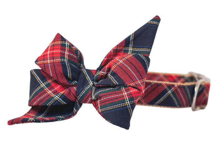 Plaid dog collar in red tartan, paired with a dramatic belle bow featuring upward peaks and wide folds. The belle bow and collar are made from the same patterned fabric.