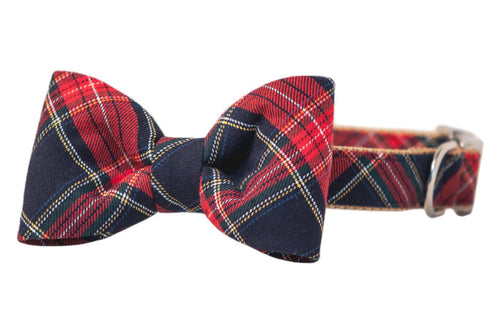 Classic bow tie dog collar in a red tartan pattern. The bow tie is centered and shaped evenly, and the collar has a metal buckle and D-ring.