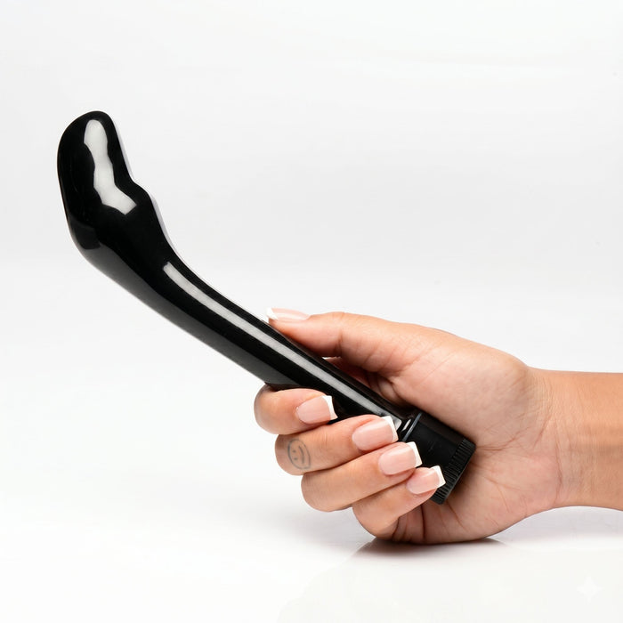 Hand holding the Essential Prostate Vibe showing the curved shaft, targeted prostate tip, and adjustable control dial at the base