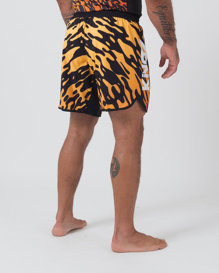 Kingz Flame Shorts Orange Black - Full Body Left Side Profile 3/4 View Male Athlete Bold Orange Black Tiger Flame Pattern Grappling Shorts KINGZ White Text Right Outer Thigh Side Vent Hem Competition Cut Matching Flame Rashguard Bare Feet Men's No-Gi BJJ [color:Black/Flame]