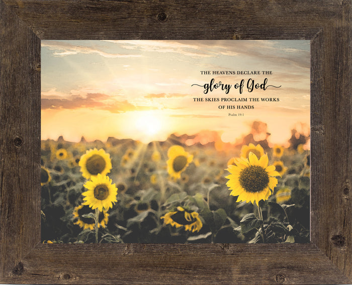 Framed Psalm 19:1 wall art with sunflower field, golden sunrise, and the verse “The heavens declare the glory of God”