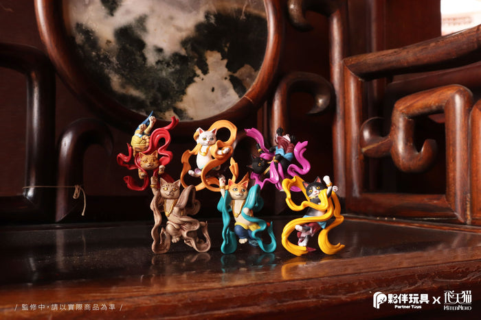 Hitenneko Blind Box Series figurines: group of small toys including cat statues with scarves and ribbons.