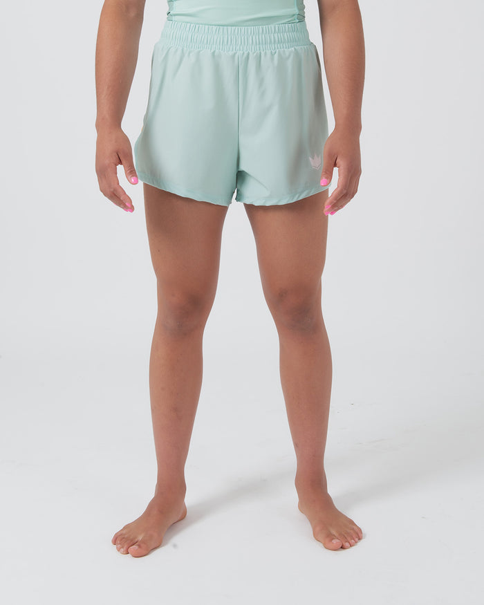 Kingz Hybrid Women's Shorts Terra Green - Full Body Front View Female Athlete Mint Light Green Color White Crown Logo Left Thigh High-Rise Elastic Waistband Competition Cut Women's Grappling Shorts No-Gi BJJ [color:Light Green]
