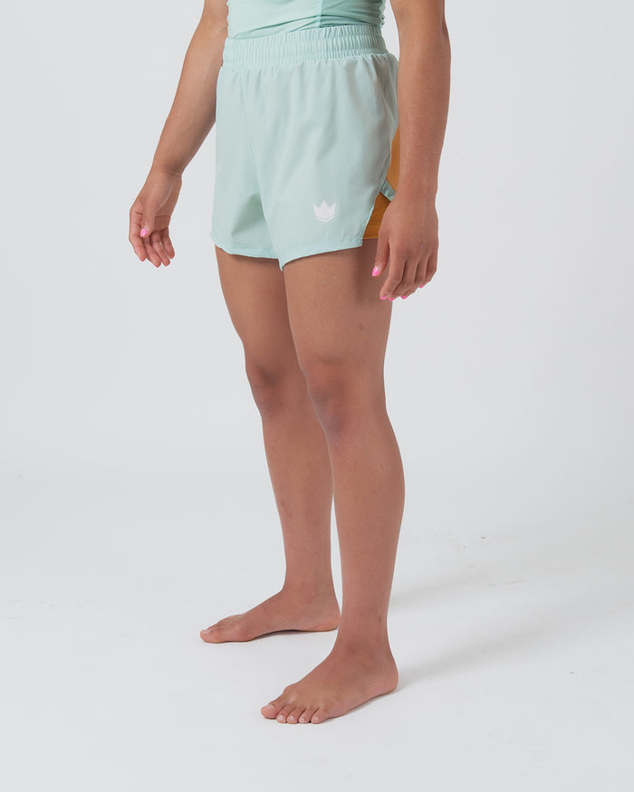 Kingz Hybrid Women's Shorts Terra Green - Full Body Front View Wide Stance Female Athlete Mint Light Green Color Pink Crown Logo Left Thigh Elastic Waistband Competition Cut Women's Grappling Shorts No-Gi BJJ [color:Light Green]