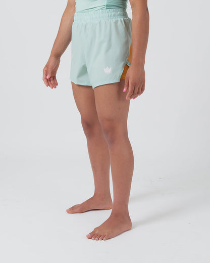 Kingz Hybrid Women's Shorts Terra Green - Full Body Front View Wide Stance Female Athlete Mint Light Green Color Pink Crown Logo Left Thigh Elastic Waistband Competition Cut Women's Grappling Shorts No-Gi BJJ [color:Light Green]