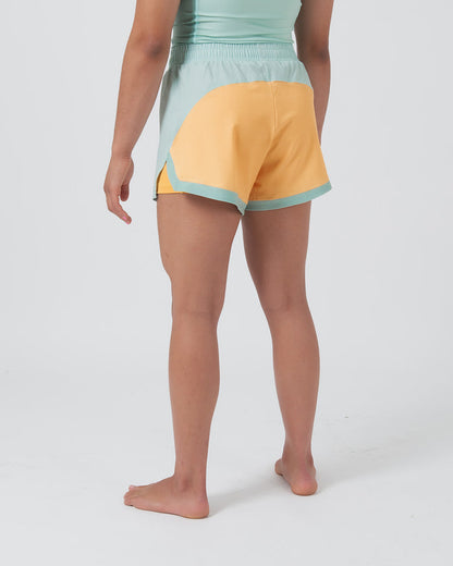 Kingz Hybrid Women's Shorts Terra Green - Full Body Left-Back Side Profile Female Athlete Two-Tone Design Mint Green Front Panel Golden Yellow Back Panel Mint Green Waistband Color Block Women's Grappling Shorts No-Gi BJJ [color:Light Green]
