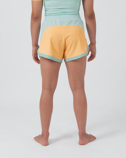 Kingz Hybrid Women's Shorts Terra Green - Full Body Back View Female Athlete Golden Yellow Back Panel Mint Green Waistband Trim Side Accents Small Crown Badge Back Color Block Design Women's Grappling Shorts No-Gi BJJ [color:Light Green]