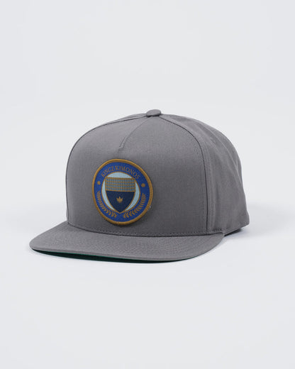 Kingz Jiu Jitsu Club Snapback Grey - Angled Front View Embroidered Round Patch Center Blue Gold Design Flat Brim Structured Fit Adjustable Snapback Cap BJJ Training Apparel [color:Grey]
