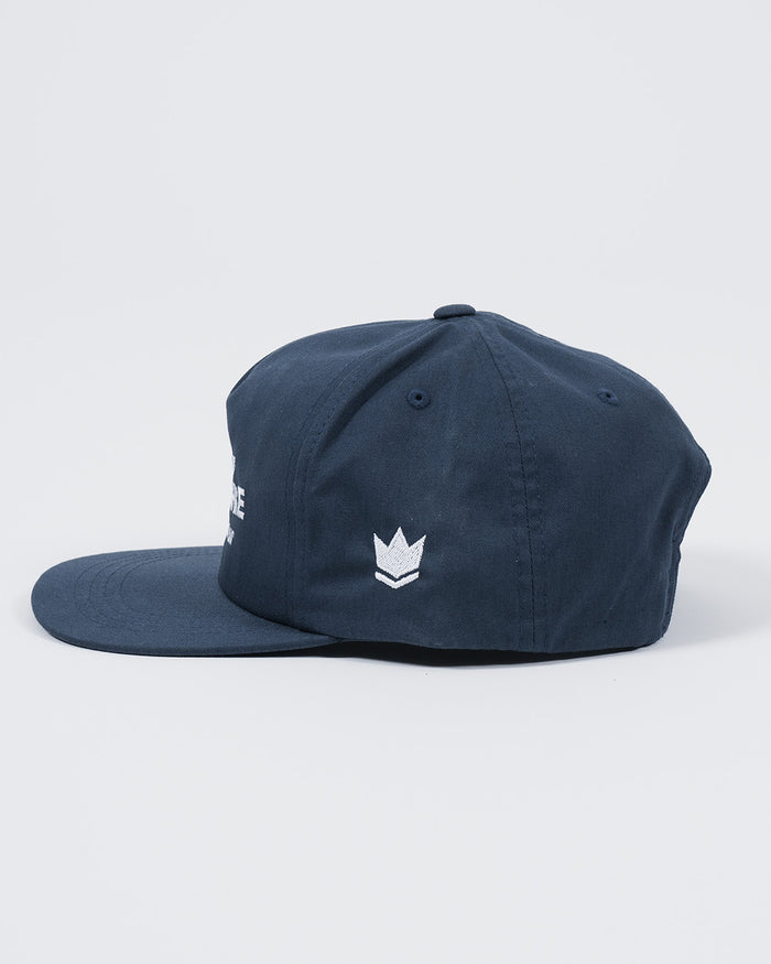 Kingz Jiu Jitsu Culture Five Panel Navy - Side View Navy Hat White Embroidered Crown Badge Left Panel Flat Brim Classic Fit Five Panel Design BJJ Training Apparel [color:Navy]