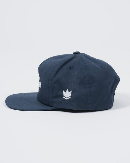 Kingz Jiu Jitsu Culture Five Panel Navy - Side View Navy Hat White Embroidered Crown Badge Left Panel Flat Brim Classic Fit Five Panel Design BJJ Training Apparel [color:Navy]