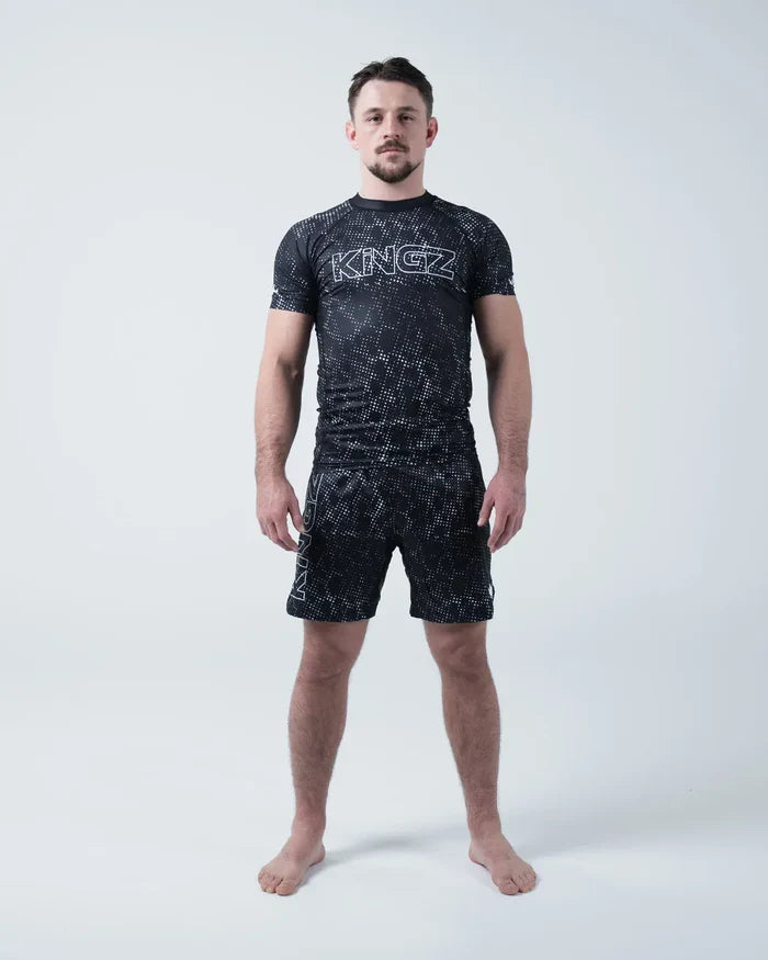 Kingz Acid Wash Rashguard Black - Full Body Straight Front View Barefoot Male Athlete Short Sleeve Large KINGZ Bold White Outline Text Acid Wash Dot Pattern Matching Shorts [color:Black/Acid]