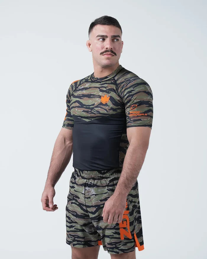 Kingz Always Hunting Rashguard Green Camo - Full Body 3/4 Angled Front View Male Athlete Short Sleeve Tiger Camo Orange Crown Logo KINGZ Originals Badge Camo Shorts [color:Green Camo]
