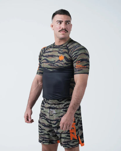 Kingz Always Hunting Rashguard Green Camo - Full Body 3/4 Angled Front View Male Athlete Short Sleeve Tiger Camo Orange Crown Logo KINGZ Originals Badge Camo Shorts [color:Green Camo]