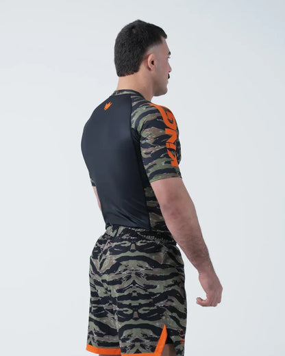 Kingz Always Hunting Rashguard Green Camo - Full Body 3/4 Back View Right Side Male Athlete Short Sleeve Tiger Camo Orange Crown Logo Black Back Panel Camo Shorts Orange Stripe [color:Green Camo]