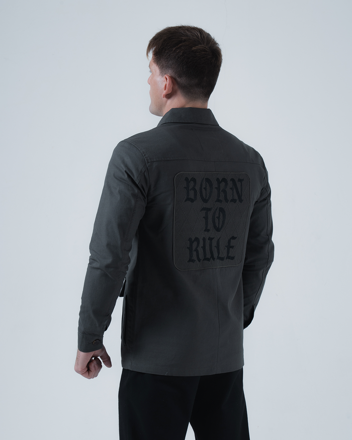 Kingz Born To Rule Canvas Jacket Military Green - Back View Male Athlete Large "BORN TO RULE" Text Black Patch Detail Long Sleeve Button Cuffs Durable Fabric Outerwear BJJ Training [color:Military Green]