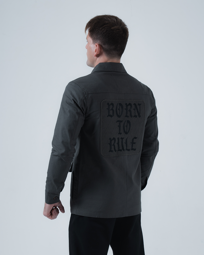 Kingz Born To Rule Canvas Jacket Military Green - Back View Male Athlete Large "BORN TO RULE" Text Black Patch Detail Long Sleeve Button Cuffs Durable Fabric Outerwear BJJ Training [color:Military Green]