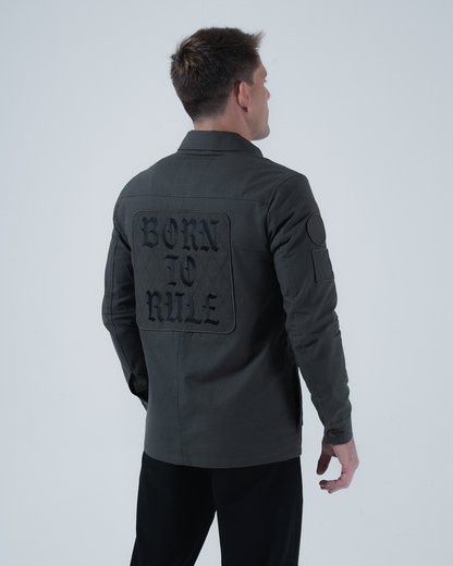 Kingz Born To Rule Canvas Jacket Military Green - Back View Male Model Large "BORN TO RULE" Text Back Patch Button Cuffs Quilted Texture Arm Patch Tailored Fit Outerwear BJJ Training [color:Military Green]