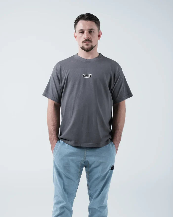 Kingz Box Tee - Front View Hands in Pockets - KINGZ Label Relaxed Fit Boxy Silhouette - Grey BJJ T-Shirt [color:Grey]