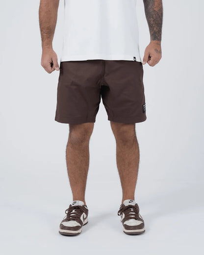 Kingz Casual Gi Shorts Brown Dark Chocolate - Full Body Front View Male Athlete Dark Brown Ripstop Casual Shorts Drawstring Waistband Black Woven Kingz Label Right Thigh White T-Shirt Brown Nike Dunk Sneakers Men's BJJ Lifestyle [color:Earthy brown]