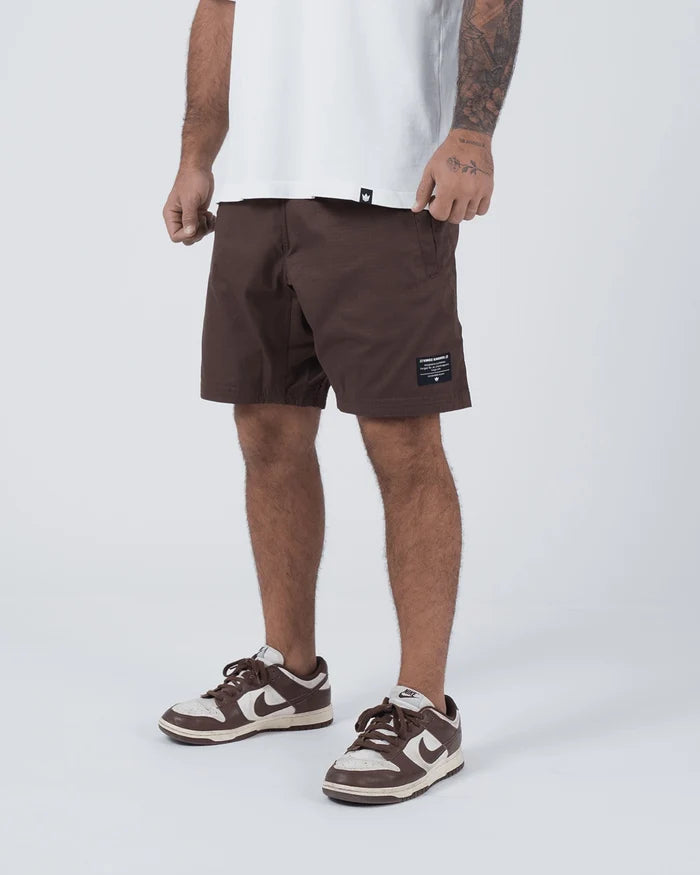 Kingz Casual Gi Shorts Brown Dark Chocolate - Full Body Front View Standing Pose Male Athlete Dark Brown Ripstop Casual Shorts Black Woven Kingz Label Right Thigh White T-Shirt Brown Nike Dunk Sneakers Men's BJJ Lifestyle [color:Earthy brown]