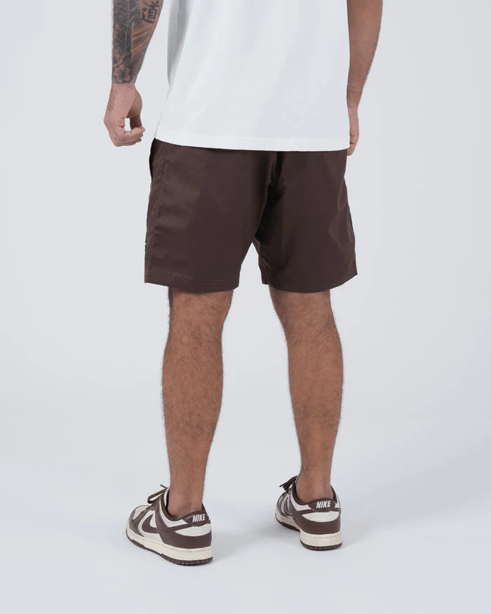 Kingz Casual Gi Shorts Brown Dark Chocolate - Full Body Front View Hands on Drawstring Male Athlete Dark Brown Ripstop Casual Shorts Black Woven Kingz Label Right Thigh White T-Shirt Brown Nike Dunk Sneakers Men's BJJ Lifestyle [color:Earthy brown]