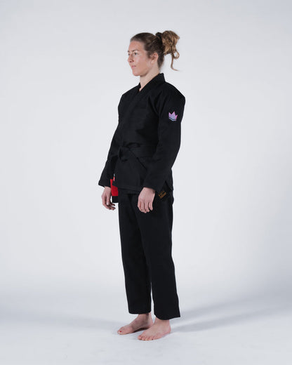 Kingz Empowered Women's Jiu Jitsu Gi - Black - Full Body Side View Female Athlete Black Crown Badge Left Arm Durable Fabric Tailored Fit BJJ Gi Training [color:Black]