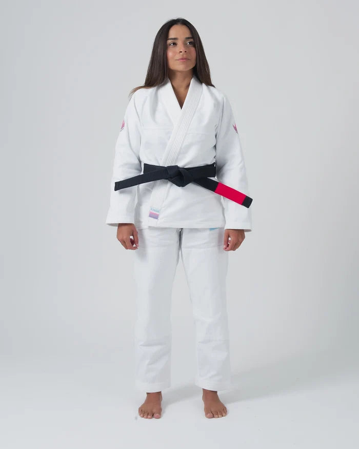 Kingz Empowered Women's Jiu Jitsu Gi - White - Full Body Front View Female Athlete White Gi Pink Shoulder Accents Black Belt KINGZ Patch Hem Durable Fabric Women's BJJ Gi Training [color:White]
