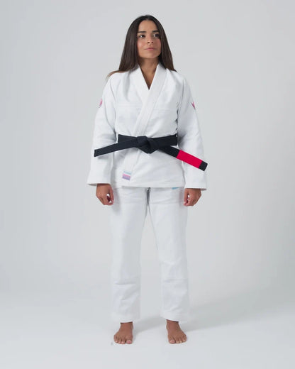 Kingz Empowered Women's Jiu Jitsu Gi - White - Full Body Front View Female Athlete White Gi Pink Shoulder Accents Black Belt KINGZ Patch Hem Durable Fabric Women's BJJ Gi Training [color:White]