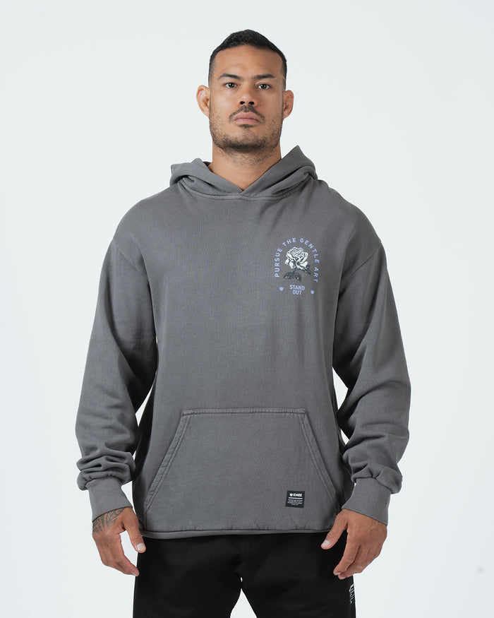 Grey BJJ hoodie front view on adult male model showing Pursue The Gentle Art rose chest graphic [color:Grey]