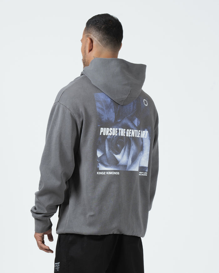 Grey BJJ hoodie back three-quarter view on adult male model displaying Pursue The Gentle Art rose print [color:Grey]