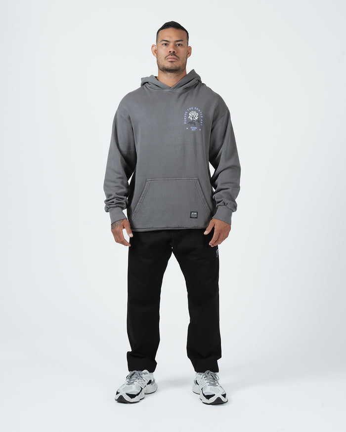 Grey BJJ hoodie full body lifestyle shot with adult male model in black joggers and grey sneakers [color:Grey]