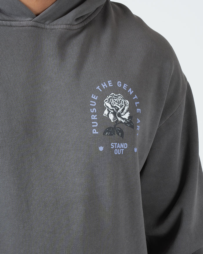 Grey BJJ hoodie chest closeup of Pursue The Gentle Art circular rose emblem and Stand Out screen print [color:Grey]