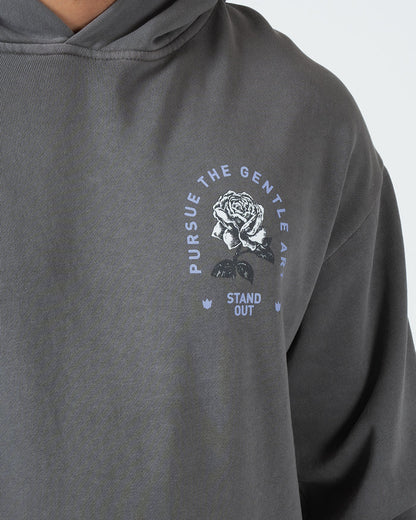 Grey BJJ hoodie chest closeup of Pursue The Gentle Art circular rose emblem and Stand Out screen print [color:Grey]