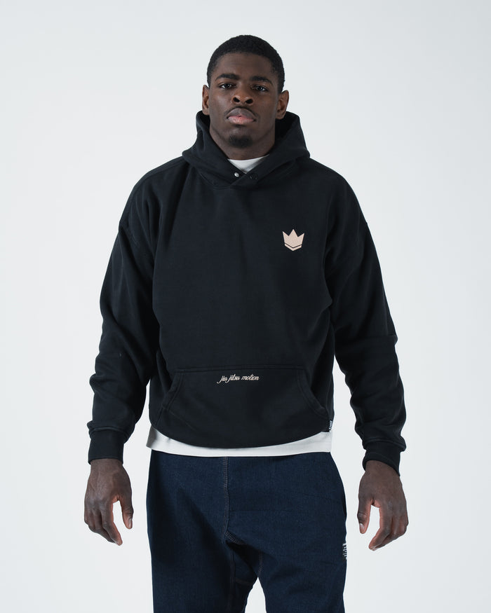 Black BJJ pullover hoodie front view on adult male model with crown logo and jiu jitsu motion script [color:Black]