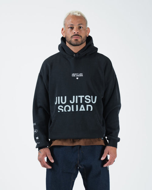 Black BJJ pullover hoodie front view on adult male model showing Jiu Jitsu Squad chest print and pocket [color:Black]