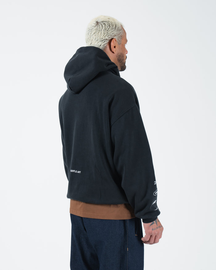 Black BJJ hoodie rear side profile on adult male model showing sleeve graphics and back detail closeup [color:Black]