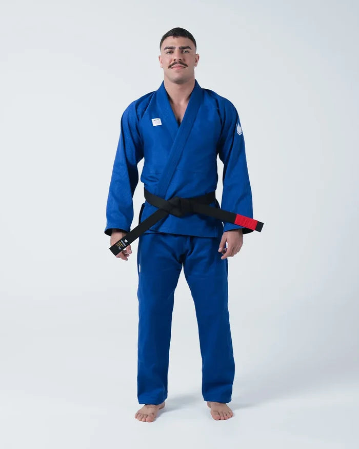 Kingz Kore V2 Jiu Jitsu Gi - Blue - Full Body Front View Male Athlete Solid Blue Gi Black Belt Red Bar White Sleeve Logo Durable Fabric BJJ Gi Training [color:Blue]