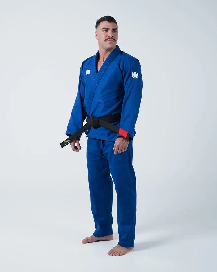 Kingz Kore V2 Jiu Jitsu Gi Blue - Full Body Front View Male Athlete Solid Blue Gi White Crown Badge Left Arm Black Belt Red Sleeve Trim BJJ Training Gi [color:Blue]